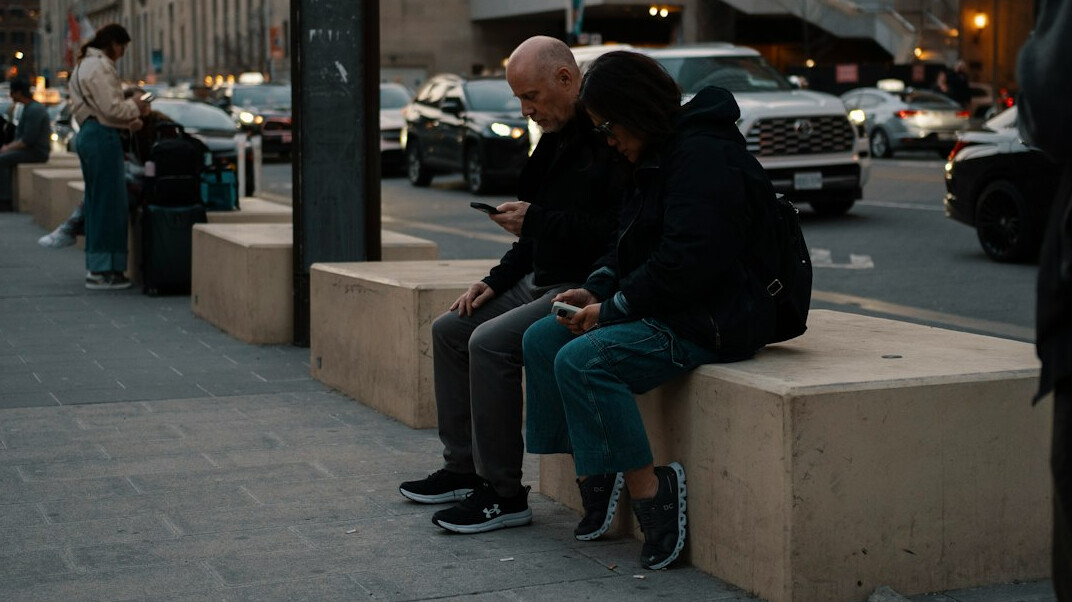 people using smartphones in public