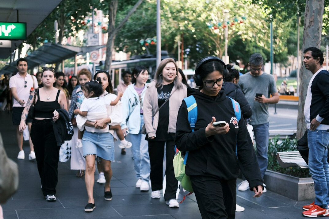 people using smartphones in public